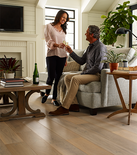 people in living room with hardwood flooring from Carpet City & Flooring Center in the Fairfield, CT area