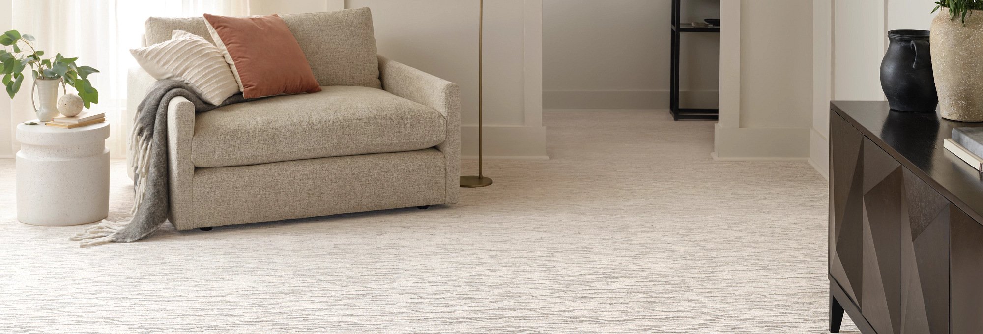 Living room with a beige armchair and beige carpet from Carpet City & Flooring Center in the Fairfield, CT area